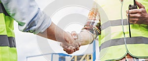 Close up handshake of two engineers on produce site