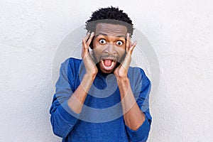 Close up handsome african american with hands to head in disbelief