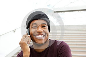 Close up handsome african american man smiling and talking with mobile phone