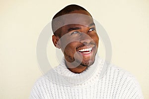 Close up handsome african american man thinking and looking away while smiling