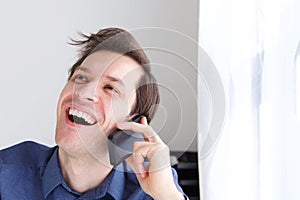Close up handsome businessman on phone call laughing