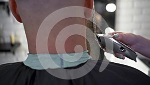 Close-up of handsome man getting beard haircut by hairdresser at barbershop. Real man grooming. barbershop