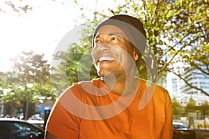Close up handsome young african american man laughing and looking away