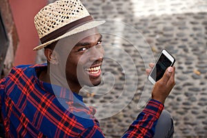 Close up handsome young black man with hat and mobile phone