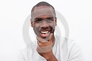 Close up handsome young black man smiling with hand to chin