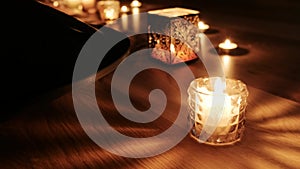 Close-up on hang drum lying in dark next to some bright candles