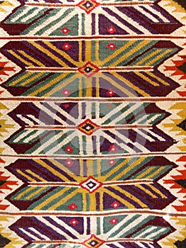 Close up of a hanged colourful handmade traditional wool rug