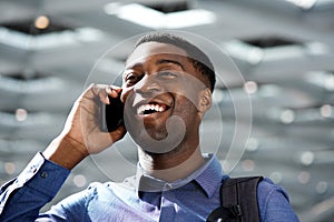 Close up happy african american businessman with cellphone in the city