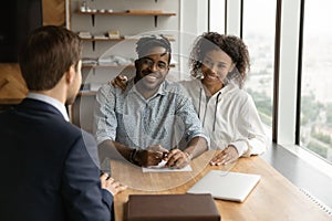 Close up happy African American couple listening to manager advisor