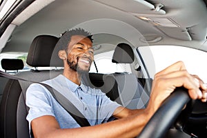 Close up happy african american man driving car