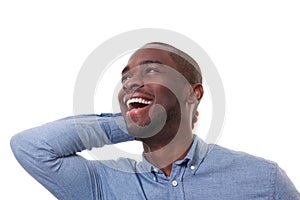 Close up happy african american man laughing against white background