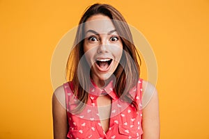 Close up of happy amazed woman with open mouth looking at camera