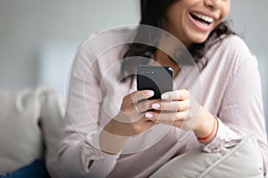 Close up of happy biracial woman using smartphone