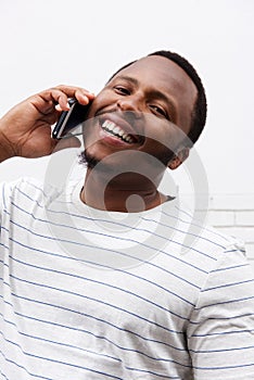 Close up happy black man laughing with cellphone