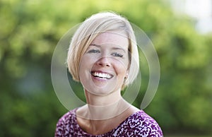 Close Up Of A Happy Blond Woman Smiling.