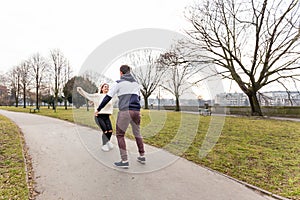 Close up of happy boyfriend holding beloved girlfriend in arms. Cute couple of young people is walking and playing in spring park