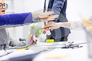 Close up of happy business team celebrating victory in office.