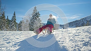 CLOSE UP: Happy Caucasian female tourist is sleighing the scenic backcountry.