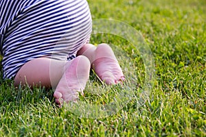 Close up. Happy Child Feet Barefoot on Green Grass. Healthy Lifestyle. Spring Time. Rear view. the concept of flatfoot