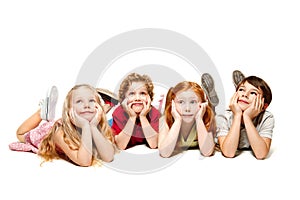 Close-up of happy children lying on floor in studio and looking up, isolated on white background