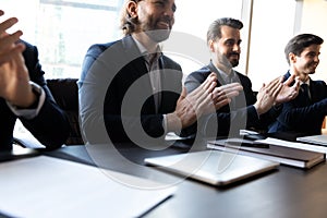 Close up happy clap hands businessmen with applicant cv.