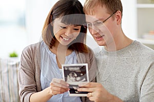 Close up of happy couple with baby ultrasound