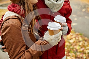 Close up of happy couple with coffee in autumn