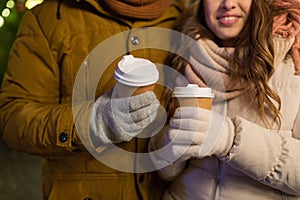 Close up of happy couple with coffee at christmas