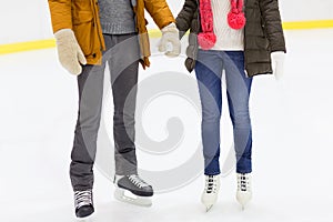 Close up of happy couple skating on ice rink