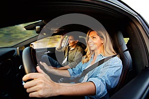 Close up happy couple smiling in car on road trip