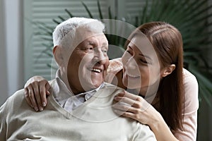 Close up happy daughter and elderly father enjoying tender moment
