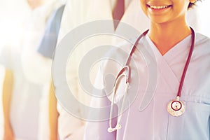 Close up of happy doctor or nurse with stethoscope