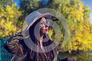 Close up of happy emotionally brunette woman with long hair and hat