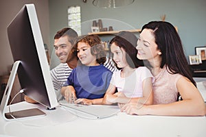 Close-up of happy family looking in computer
