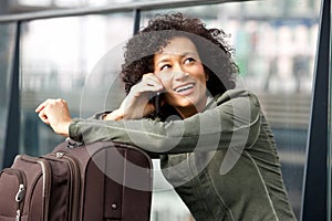 Close up happy female traveler talking on mobile phone