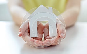 Close up of happy girl hands holding paper house