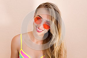 Close Up Of Happy Girl in pink sunglasses isolated. Summer holidays and fun time weekend. Summertime concept. Smiling young woman