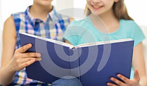 Close up of happy girls reading book at home