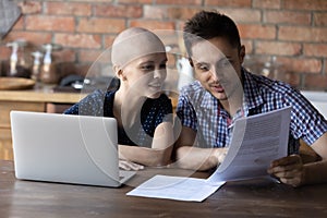 Close up happy hairless wife and husband reading good news