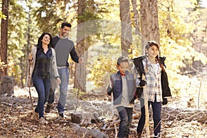 Close up of happy Hispanic family hiking in forest, close up