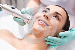 Close up of happy lady undergoing modern oxygen meso therapy