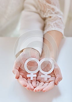 Close up of happy lesbian couple with venus symbol