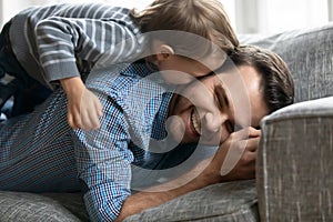 Close up happy loving father and adorable little son cuddling