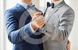 Close up of happy male gay couple dancing