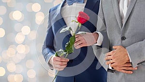 Close up of happy male gay couple holding hands