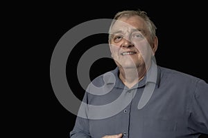 Close up of a happy mature man on a black background