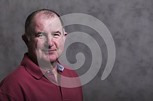 Close up of a happy mature man on a grey background