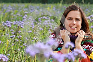 Close up of a happy mature woman in a flower field