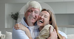 Close up happy millennial woman hugs elderly father