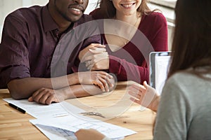 Close up of happy multiracial couple buying home photo